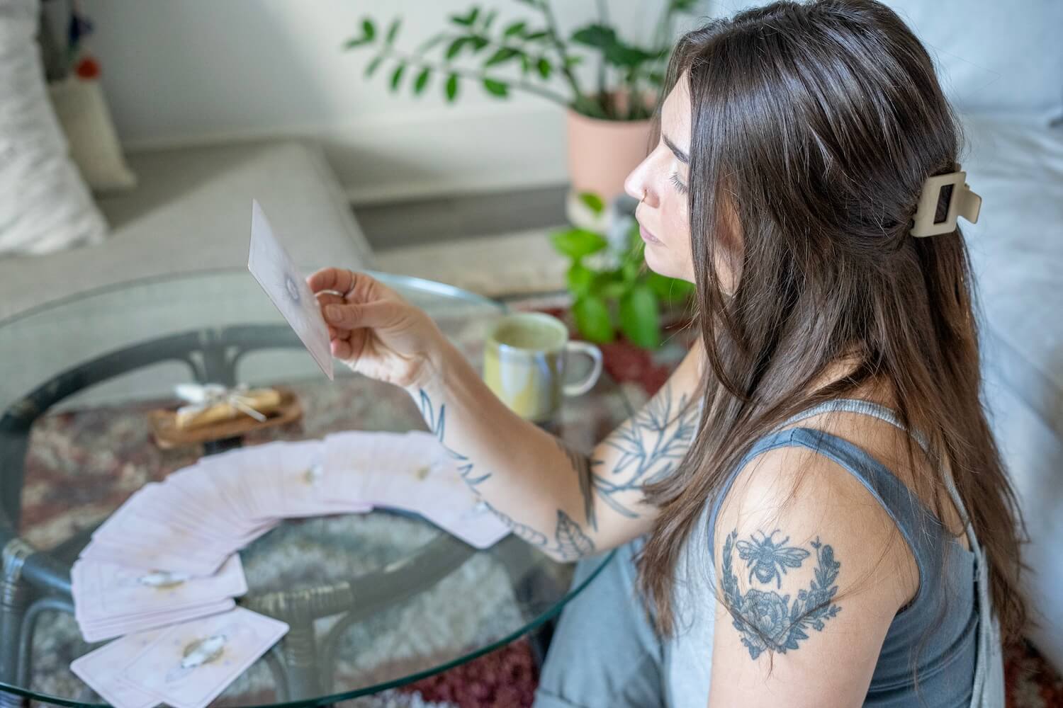 woman pulling oracle cards as part of microdosing integration practice for anxiety