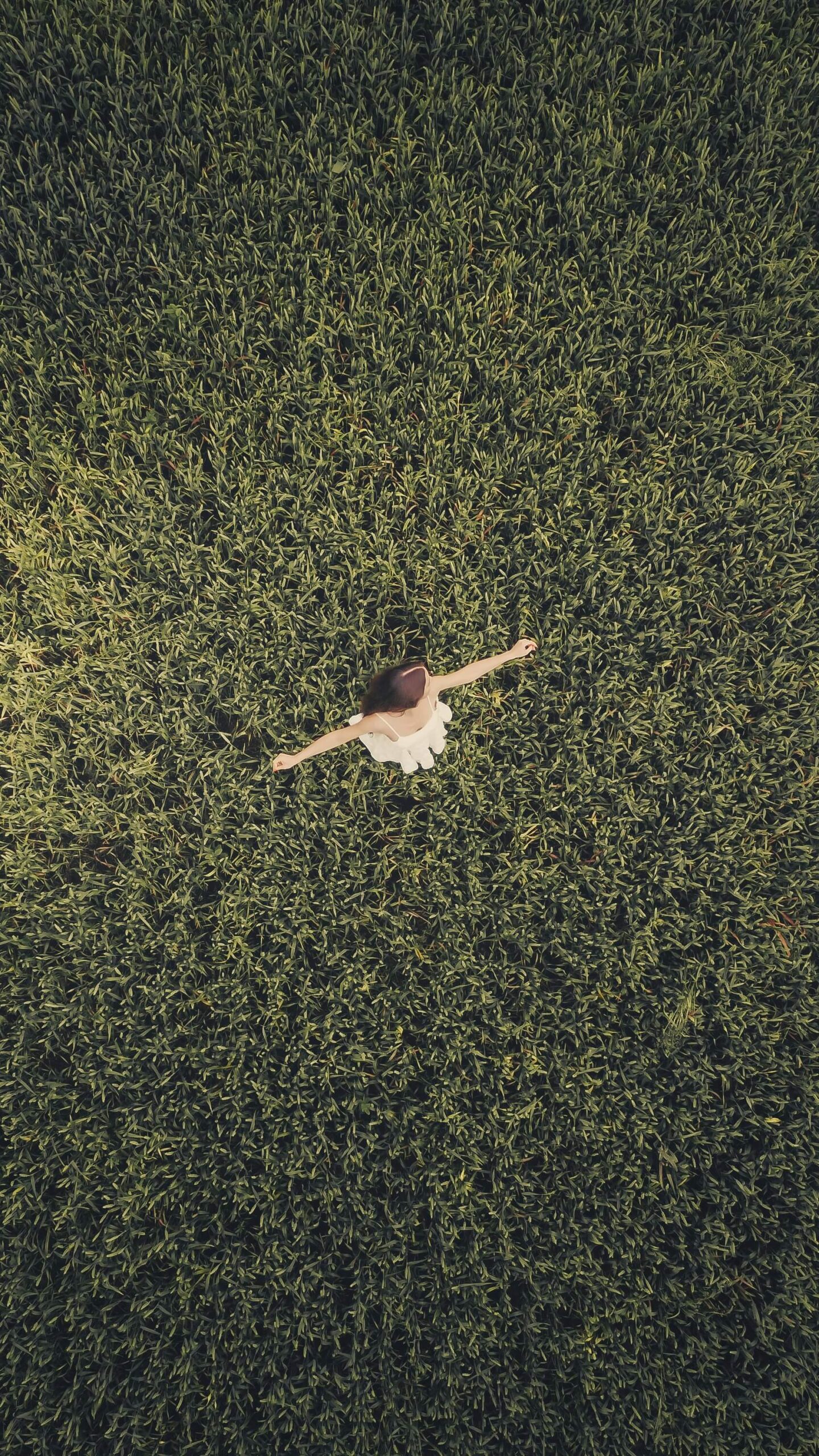 girl dancing in a field integrating psychedelics overcoming limiting beliefs